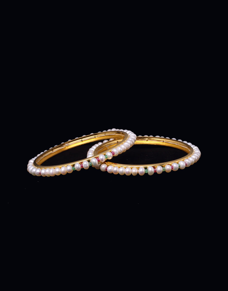 Beautiful white pearl bangles beaded with luxurious Ruby and Emerald