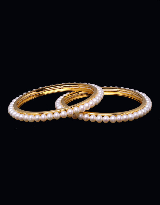 Round single incomparable white pearls bangles embellished with  Gold alloy Base