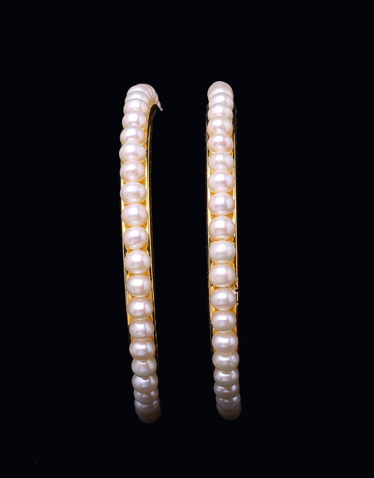 Round single incomparable white pearls bangles embellished with  Gold alloy Base